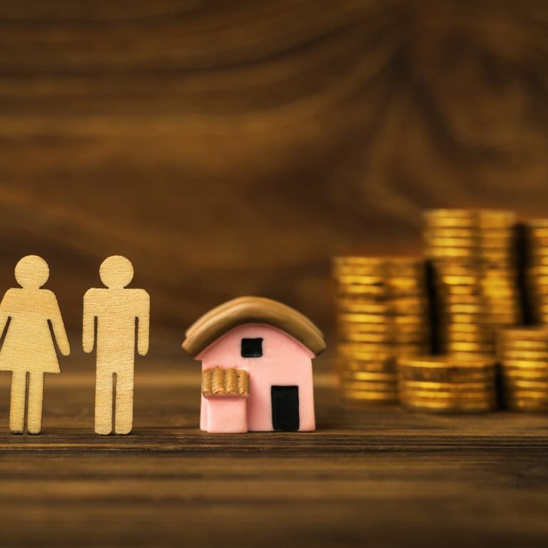 coins-house-model-female-male-wooden-figures-wooden-background-concept-housing-acquisition (1)